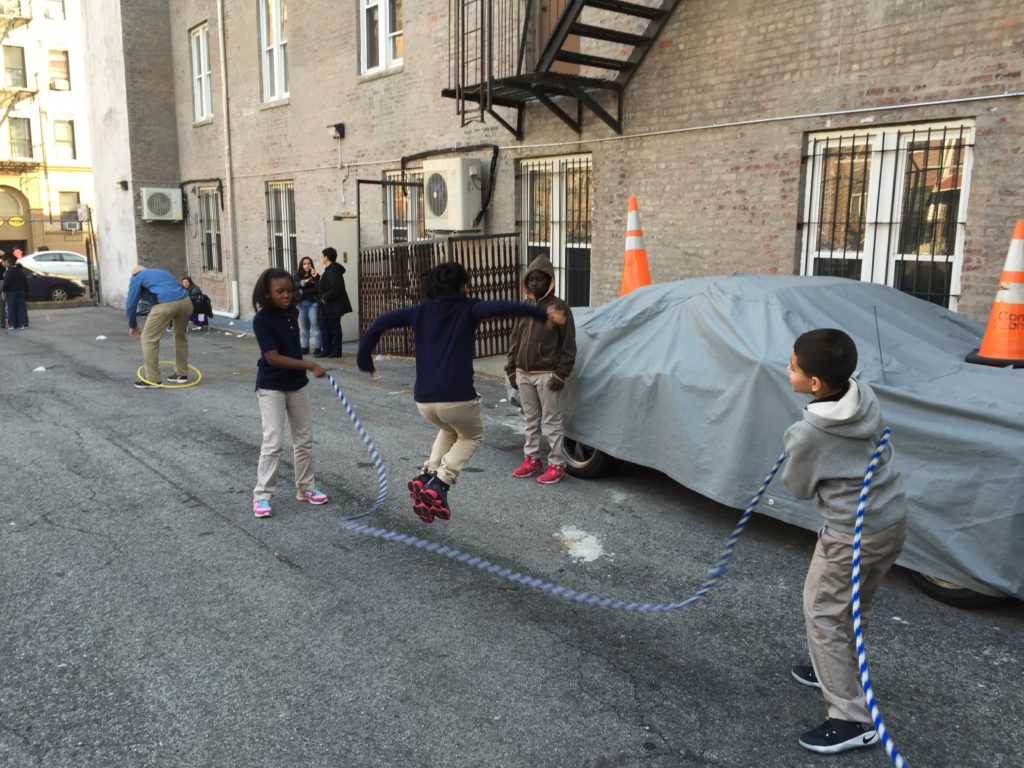 G2Kids jumping rope in the parking lot.