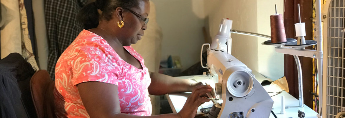 A woman sews at the G2 Work program